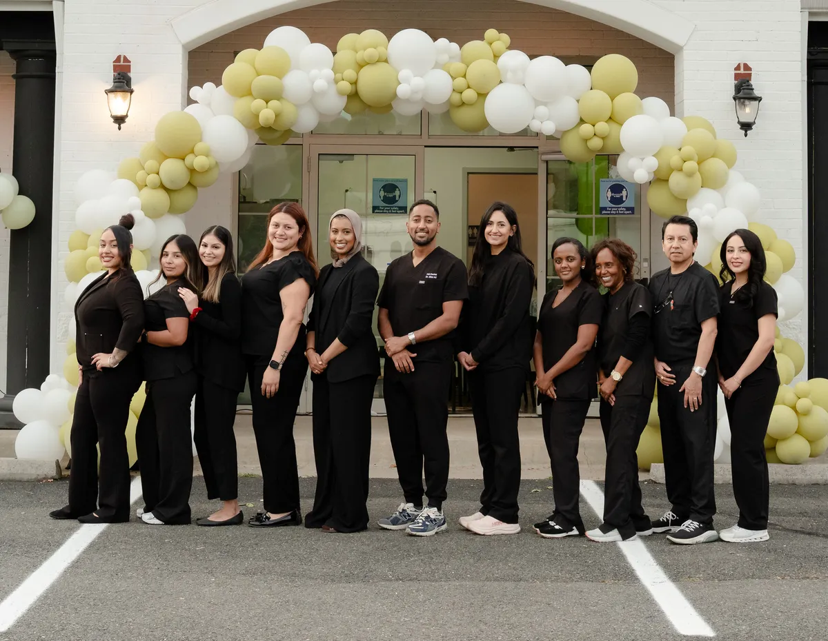 The 703 Dental team at the entrance of the Woodbridge, VA office
