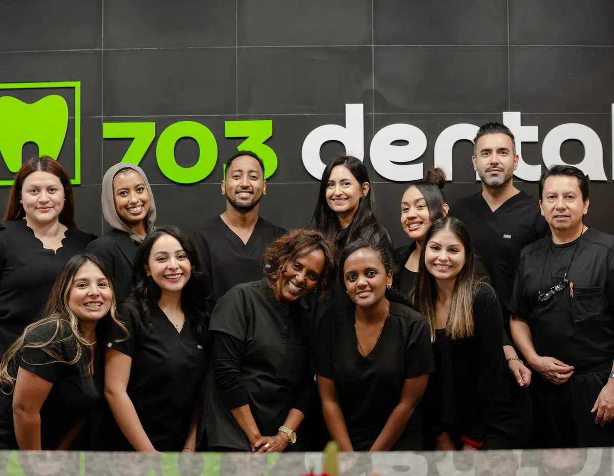 The 703 Dental team at the reception desk in Woodbridge, VA