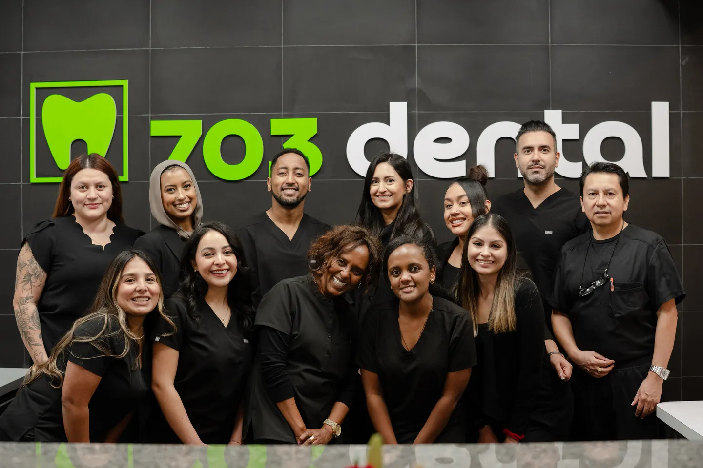 The 703 Dental team at the reception desk in Woodbridge, VA